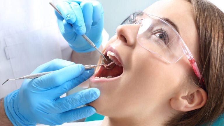 A woman being treated by a dentist