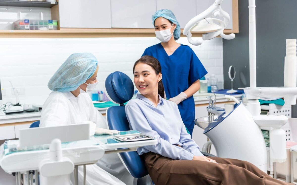 Patient consulting with Dentist and Dental Assistant