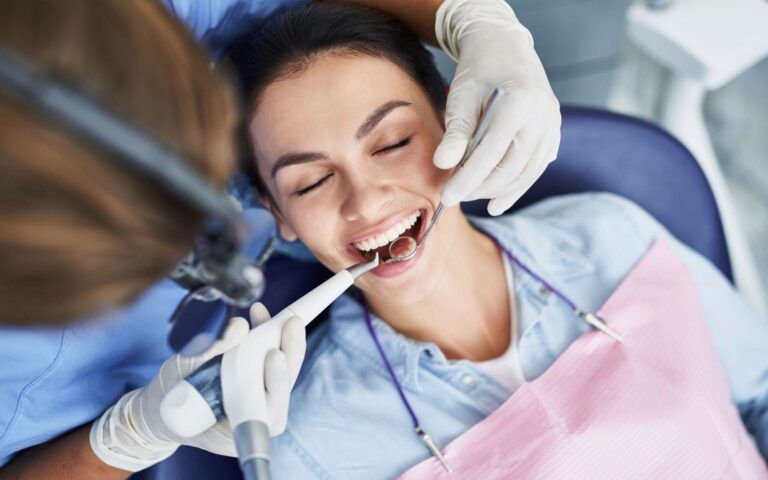 Woman Recieving Dental Cleaning