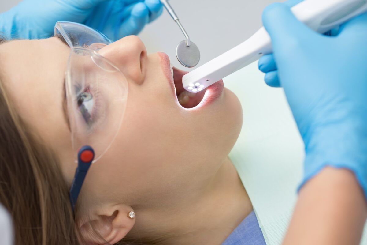 intraoral camera being used in female patients mouth