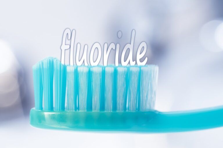 blue toothbrush with the word "fluoride" on top